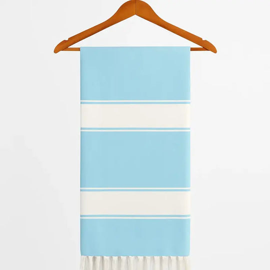 Towel with blue and white stripes on a wooden hanger against a white background