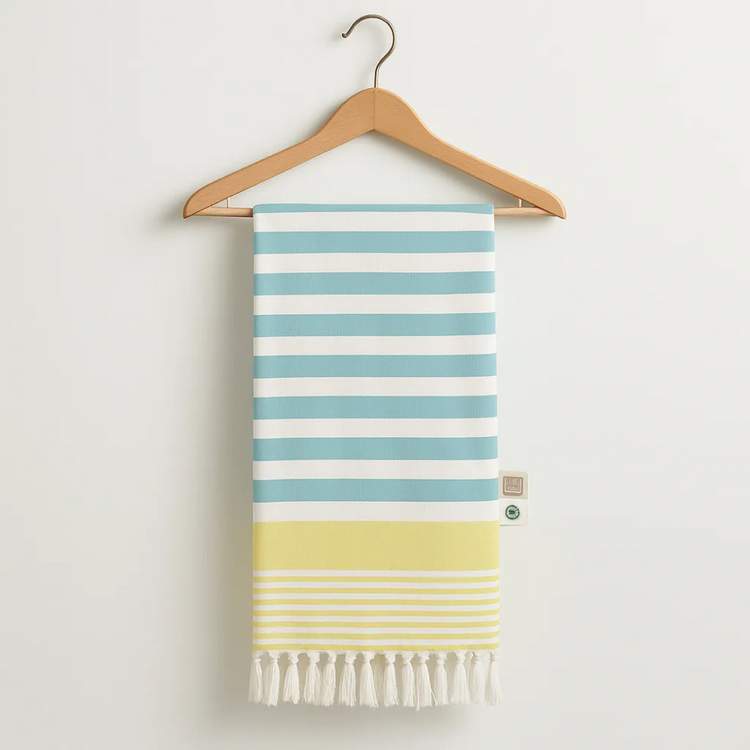 Striped towel with blue and yellow stripes on a wooden hanger against a white background