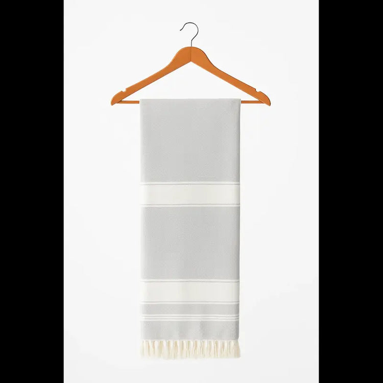 Gray and white striped towel on a wooden hanger against a white background