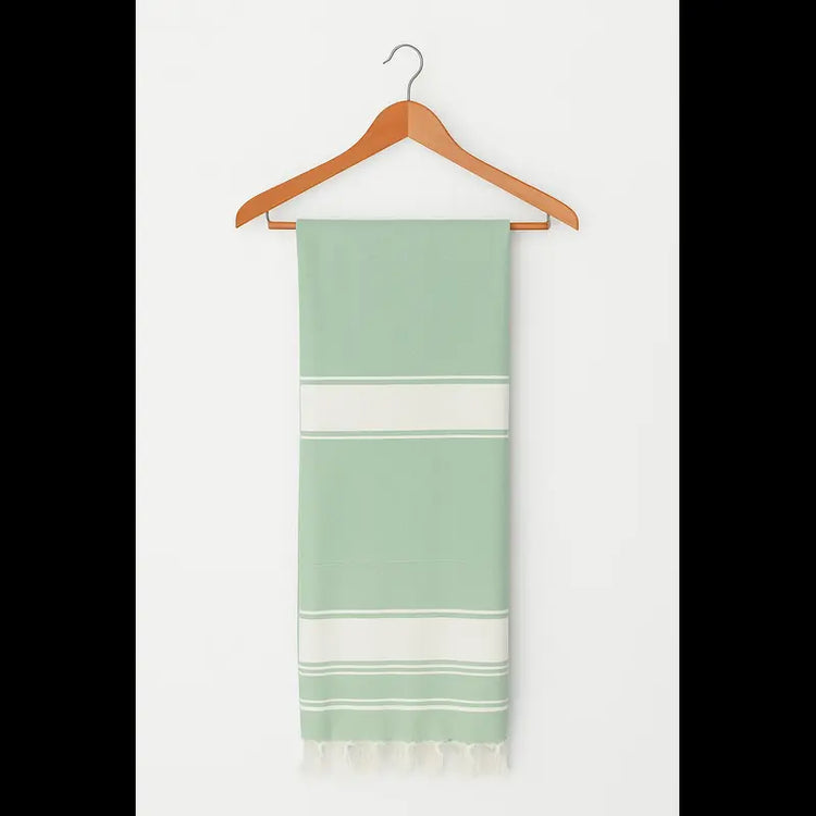 Green and white striped towel on a wooden hanger against a white background
