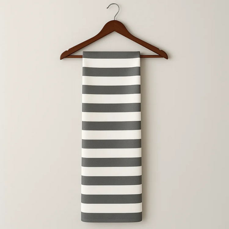 Striped towel on a wooden hanger against a plain background