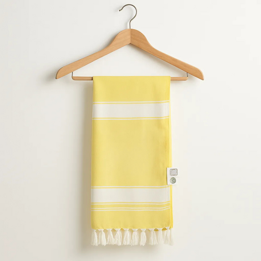 Yellow towel with white stripes and fringes on a wooden hanger against a white background
