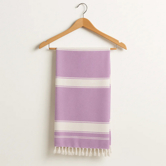 Purple towel with white stripes on a wooden hanger against a white background